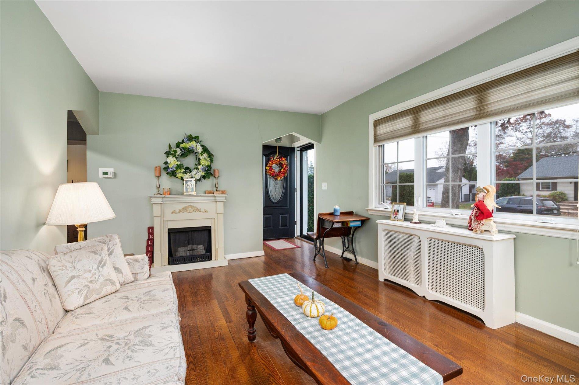 2271 Locust Street Merrick, NY 11566 - Photo 8 of 24 a living room with furniture and a fireplace