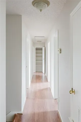 a view of a hallway with a bathroom