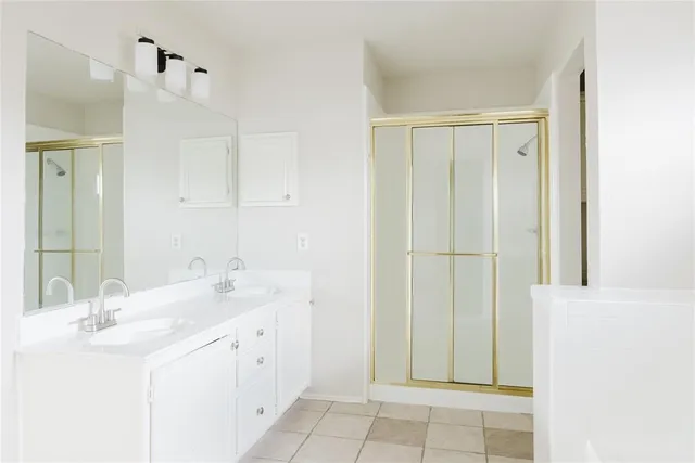 a bathroom with a double vanity sink and a mirror