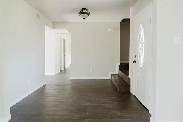 a view of hallway with wooden floor