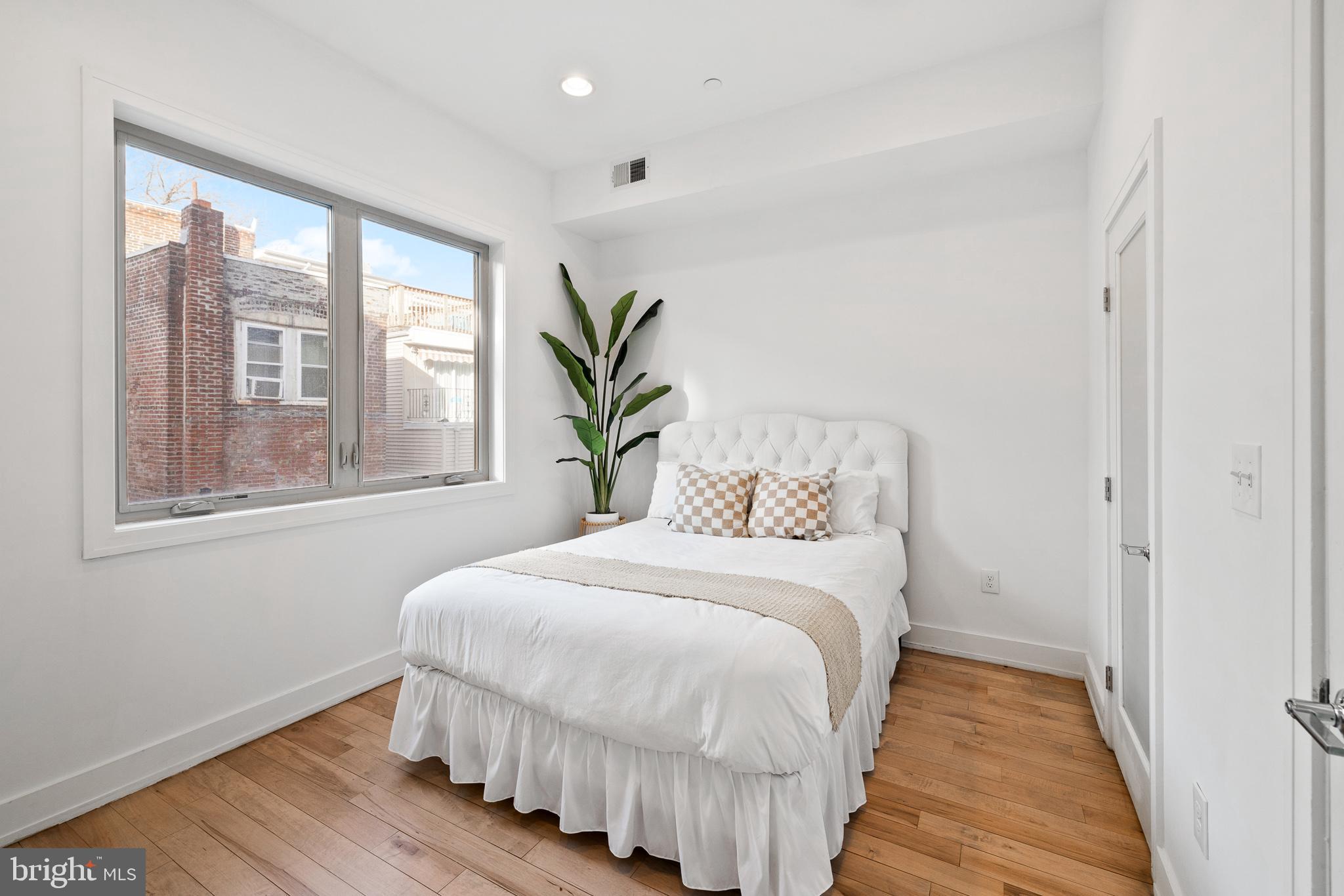 1514 Palethorp Street Philadelphia, PA 19122 - Photo 13 of 41 a bedroom with a bed and wooden floor