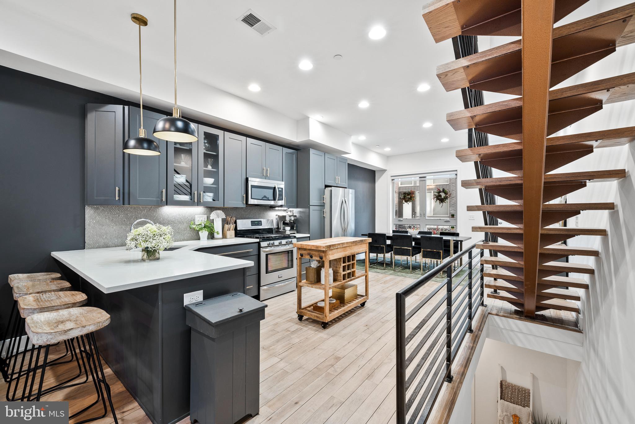 1514 Palethorp Street Philadelphia, PA 19122 - Photo 3 of 41 a kitchen with stainless steel appliances granite countertop a stove oven and a refrigerator with wooden floor