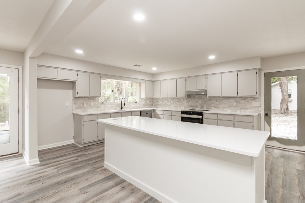 8585 McKee Road Upatoi, GA 31829 - Photo 11 of 62 a large kitchen with kitchen island a sink stainless steel appliances and cabinets