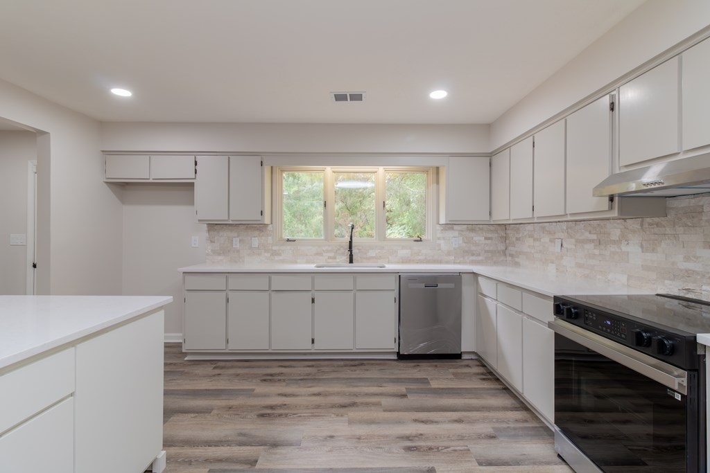 8585 McKee Road Upatoi, GA 31829 - Photo 12 of 62 a kitchen with sink cabinets and window