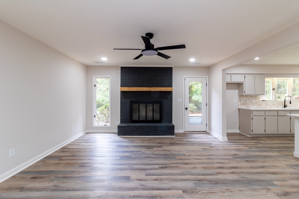 8585 McKee Road Upatoi, GA 31829 - Photo 18 of 62 a living room with stainless steel appliances granite countertop a fireplace a flat screen tv and a fireplace