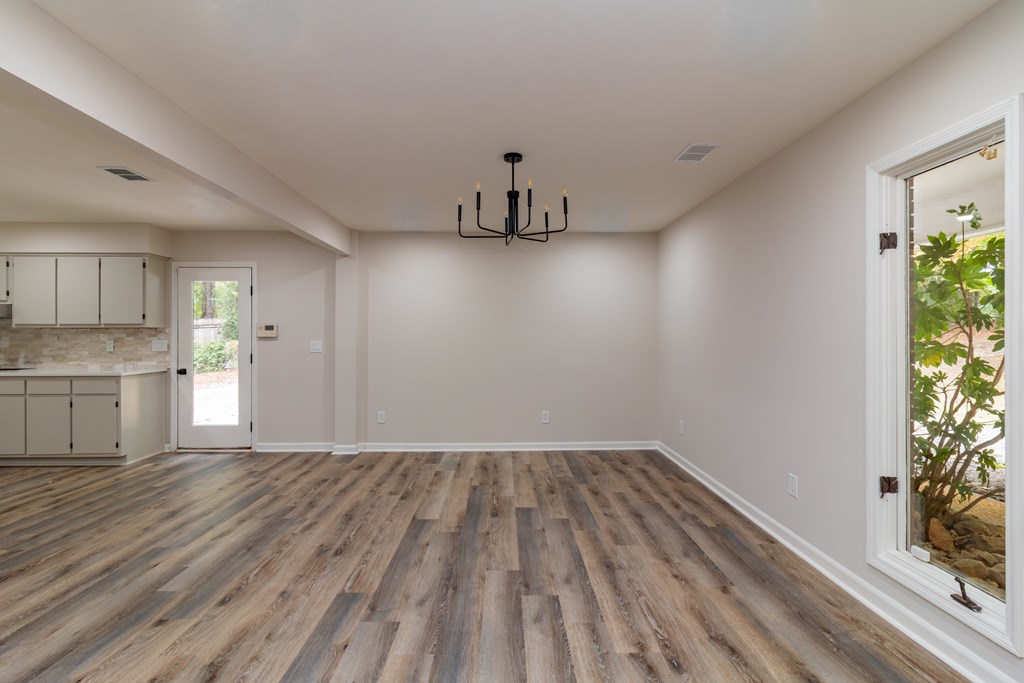 8585 McKee Road Upatoi, GA 31829 - Photo 20 of 62 a view of empty room with wooden floor and window