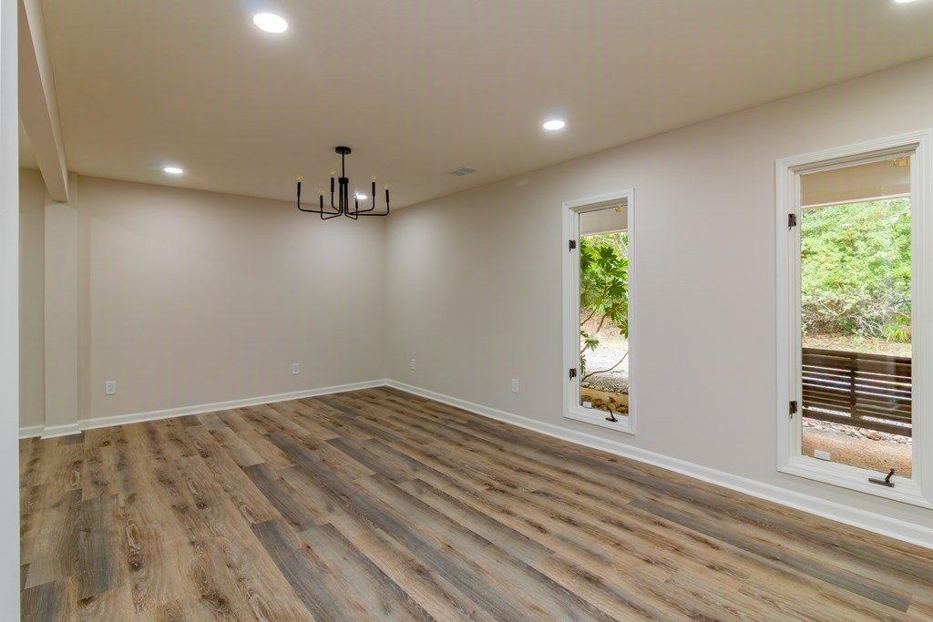8585 McKee Road Upatoi, GA 31829 - Photo 21 of 62 wooden floor in an empty room with a window