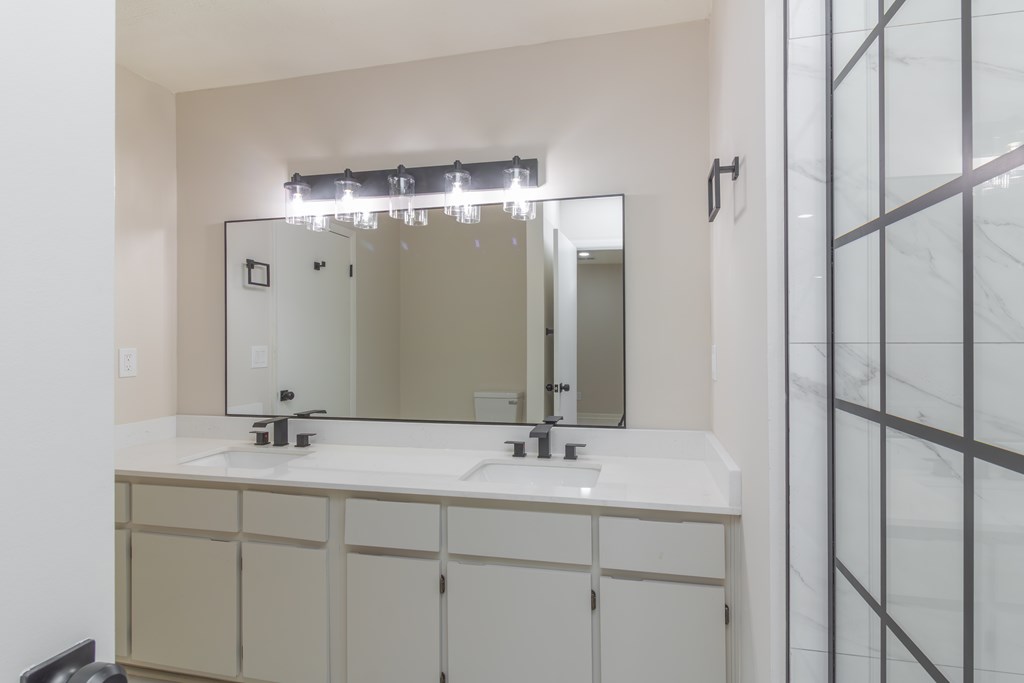 8585 McKee Road Upatoi, GA 31829 - Photo 24 of 62 a bathroom with a double vanity sink and mirror