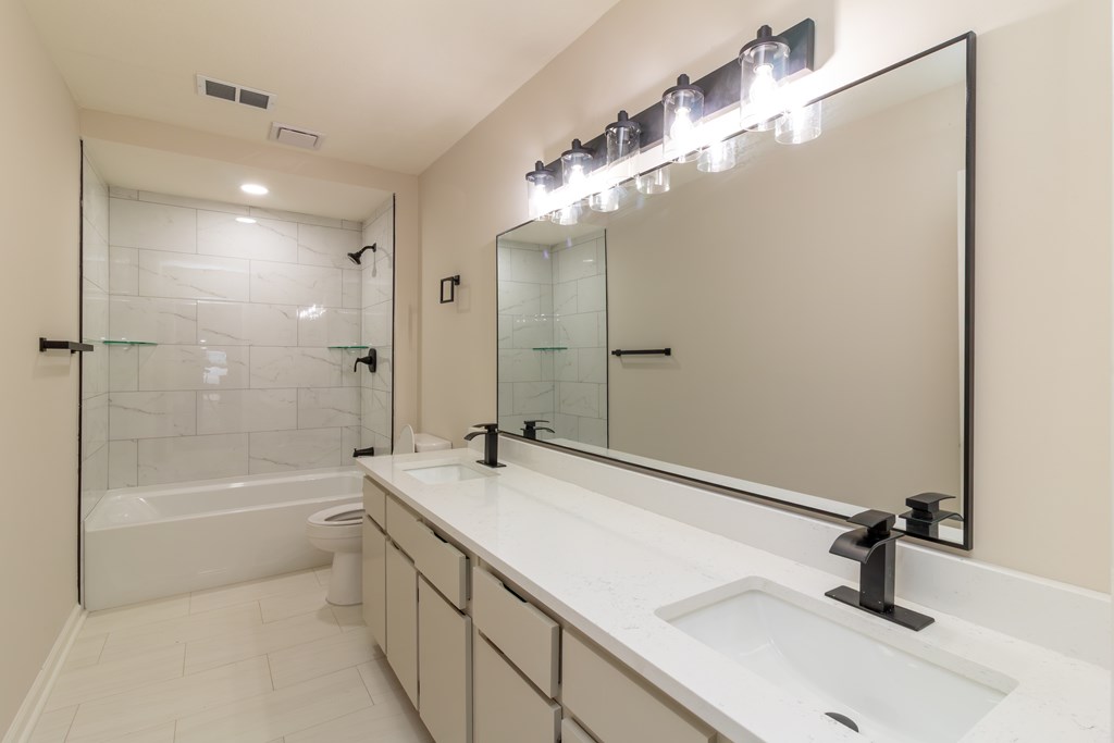 8585 McKee Road Upatoi, GA 31829 - Photo 29 of 62 a bathroom with a tub sink and mirror