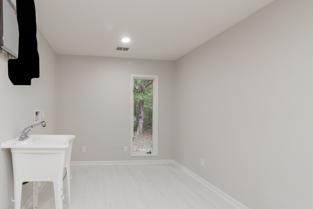 8585 McKee Road Upatoi, GA 31829 - Photo 34 of 62 a bathroom with a sink and a mirror