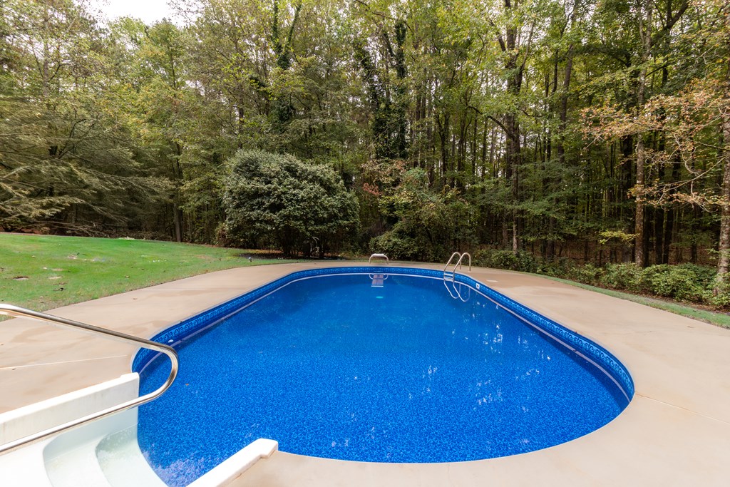 8585 McKee Road Upatoi, GA 31829 - Photo 39 of 62 a view of backyard with swimming pool and outdoor space