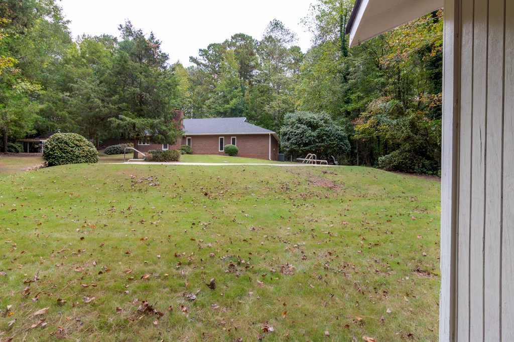 8585 McKee Road Upatoi, GA 31829 - Photo 44 of 62 a view of a backyard with large trees and plants