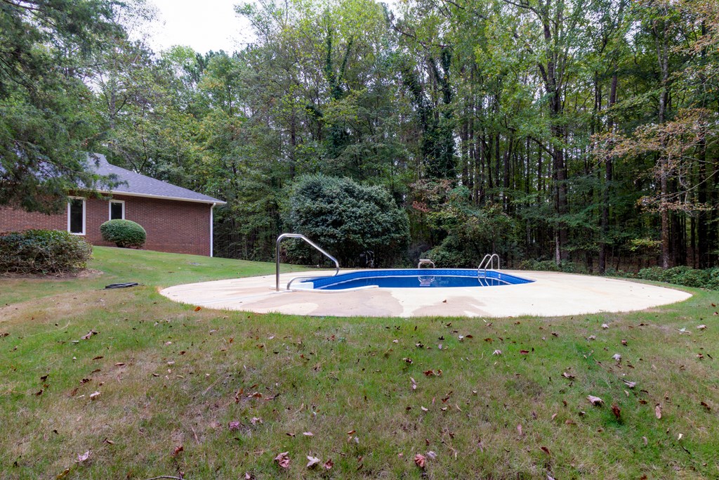 8585 McKee Road Upatoi, GA 31829 - Photo 45 of 62 a view of a house with backyard and trees