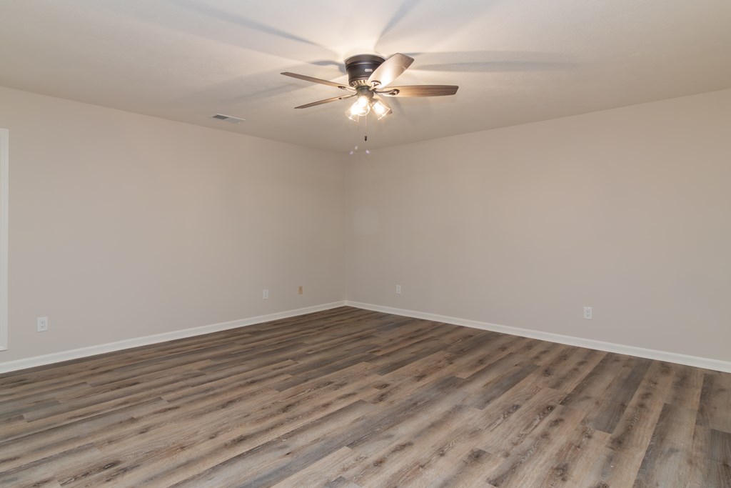 8585 McKee Road Upatoi, GA 31829 - Photo 46 of 62 a view of an empty room with wooden floor