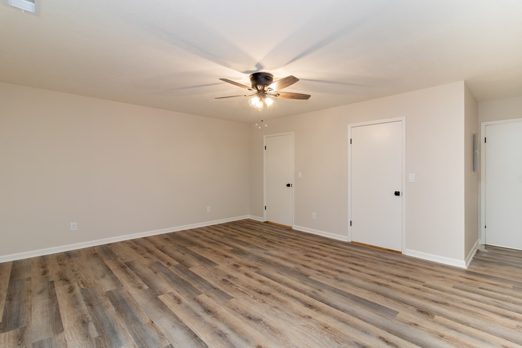 8585 McKee Road Upatoi, GA 31829 - Photo 47 of 62 a view of a room with wooden floor and a ceiling fan