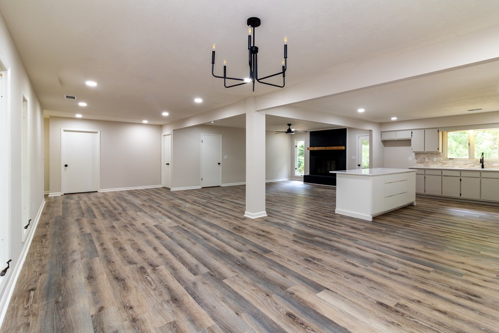8585 McKee Road Upatoi, GA 31829 - Photo 7 of 62 a view of a kitchen with wooden floor and a ceiling fan