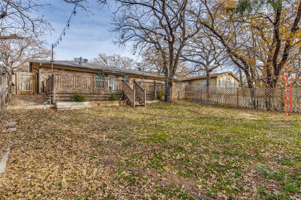 500 Lake Crest Parkway Azle, TX 76020 - Photo 20 of 23 a view of a house with a large tree and a yard