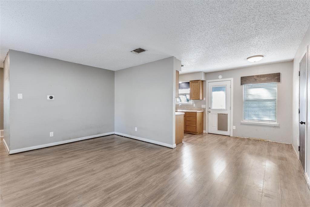 500 Lake Crest Parkway Azle, TX 76020 - Photo 5 of 23 a view of a kitchen with wooden floor and a window