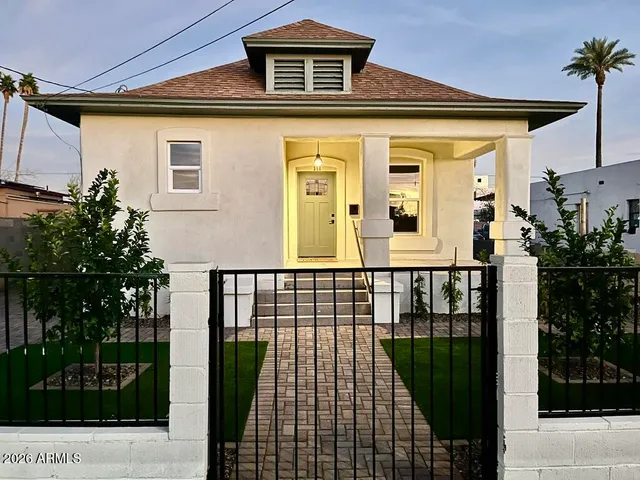 a front view of a house with a garden