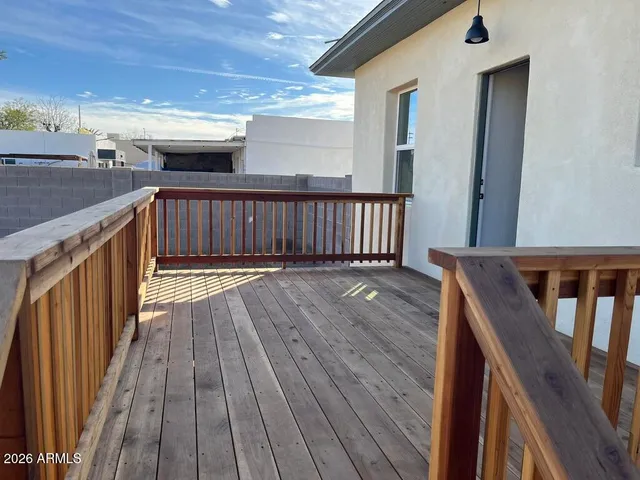 a white house with a large tree with yard
