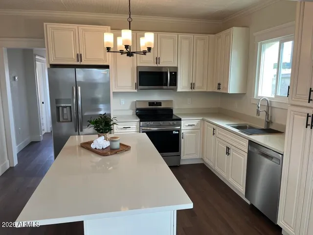 a kitchen with a sink a microwave a stove and refrigerator