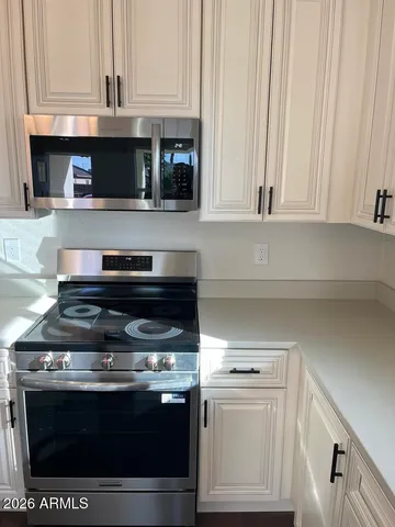 a stove top oven sitting inside of a kitchen