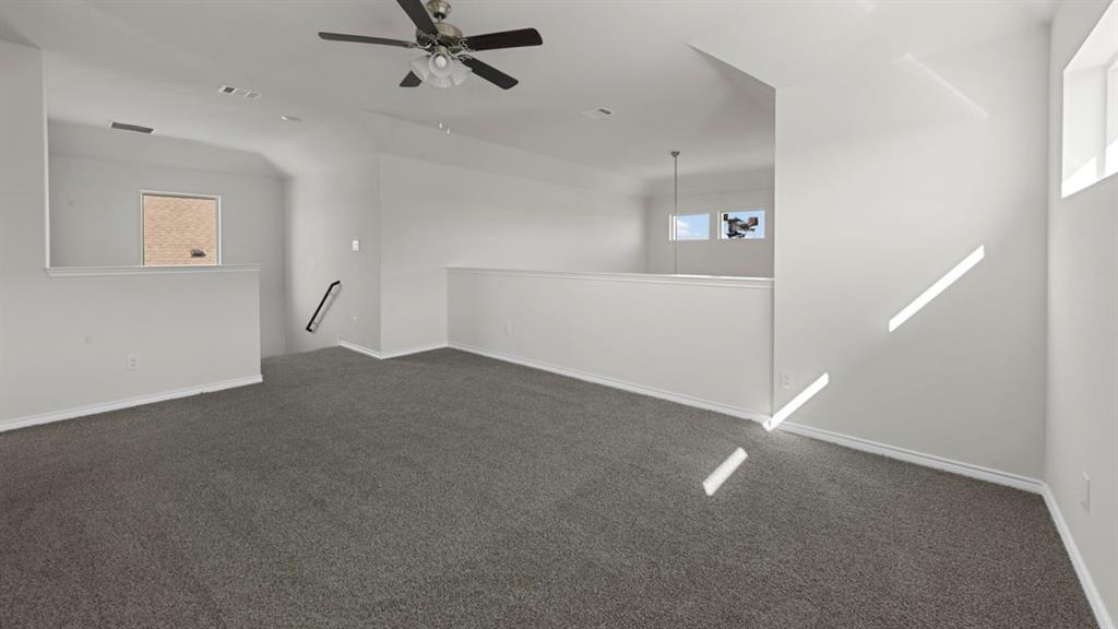 412 Carthage Street Caddo Mills, TX 75135 - Photo 21 of 32 Spacious loft area featuring neutral gray carpet and light-colored walls