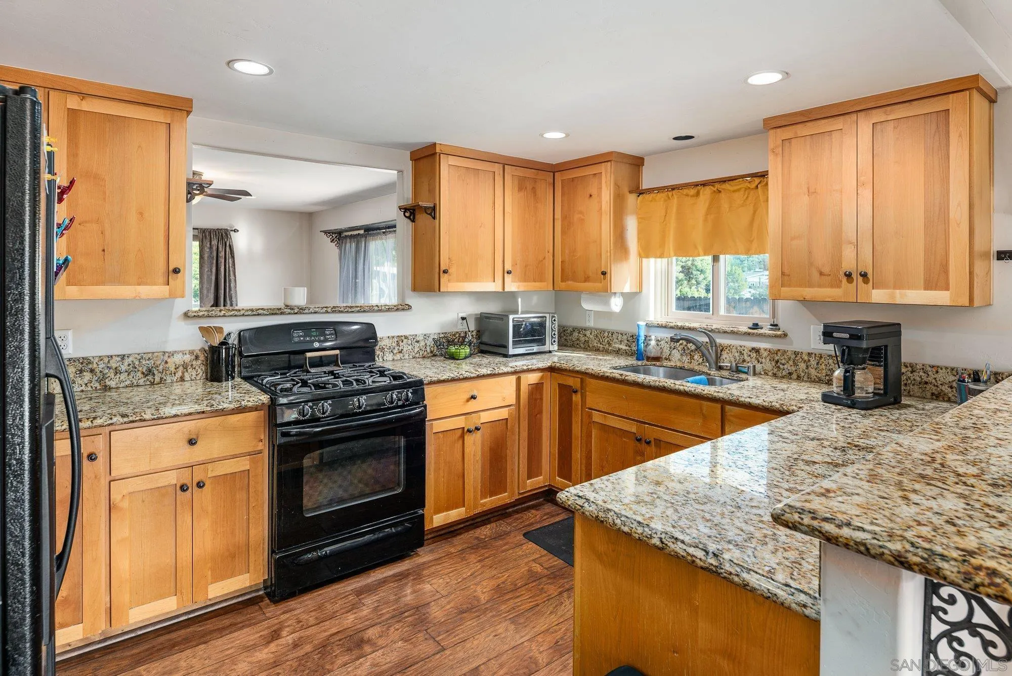 8944 Bower Lane Lakeside, CA 92040 - Photo 14 of 40 a kitchen with stainless steel appliances granite countertop wooden cabinets granite counter tops and a hard wood floors