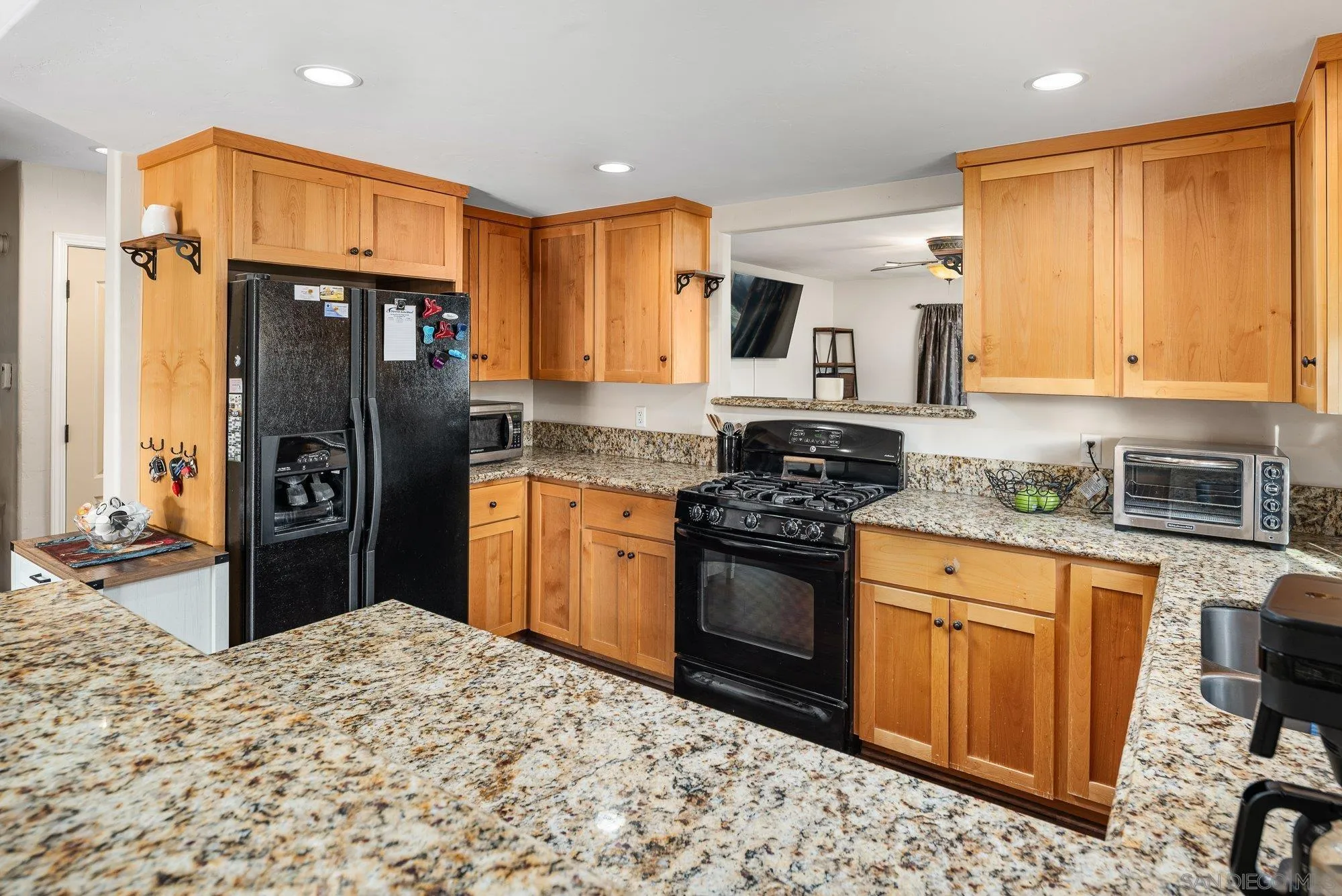 8944 Bower Lane Lakeside, CA 92040 - Photo 15 of 40 a kitchen with stainless steel appliances granite countertop a stove refrigerator sink and cabinets