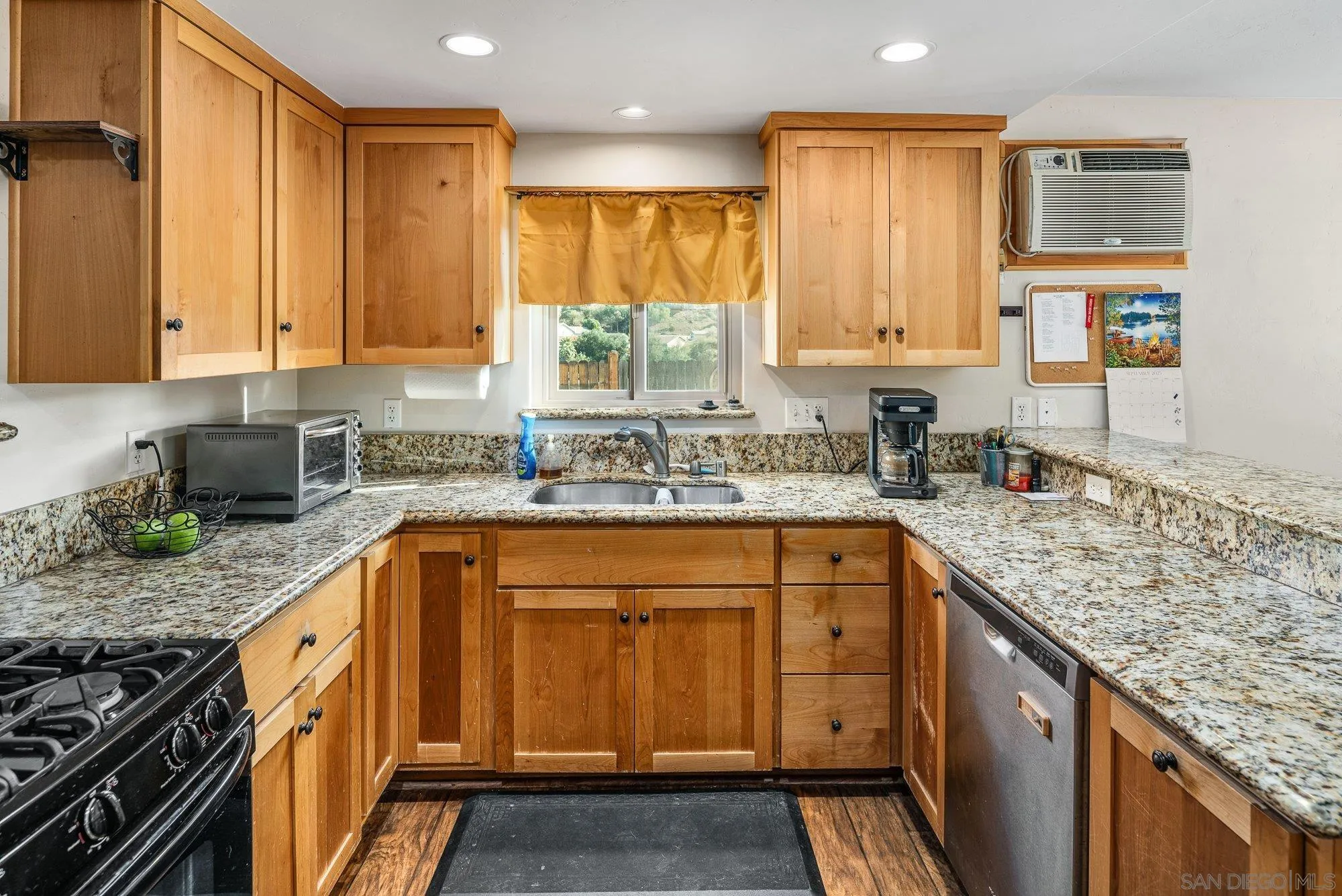 8944 Bower Lane Lakeside, CA 92040 - Photo 16 of 40 a kitchen with stainless steel appliances granite countertop a sink stove and cabinets