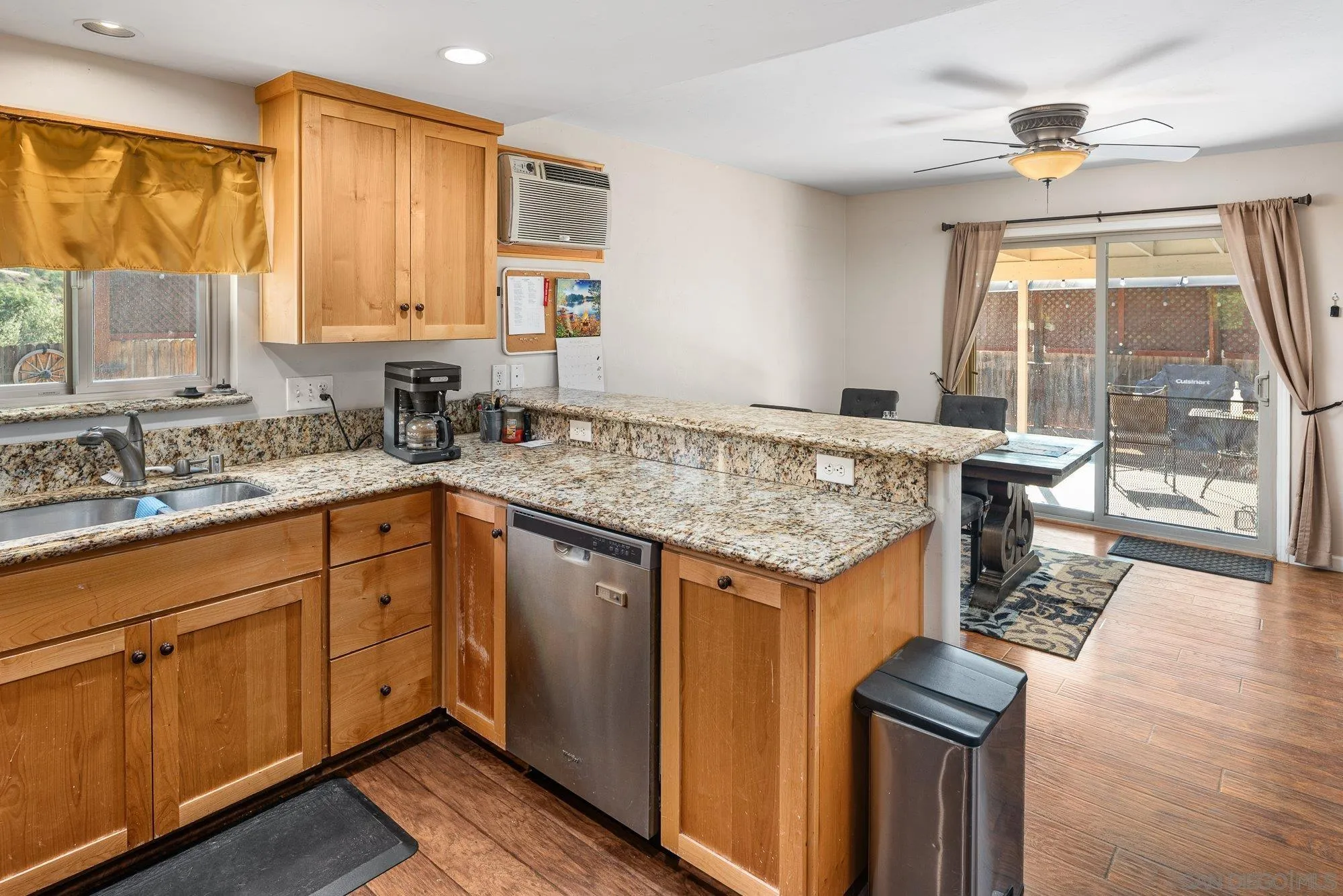 8944 Bower Lane Lakeside, CA 92040 - Photo 17 of 40 a kitchen with a stove a sink and a wooden cabinets