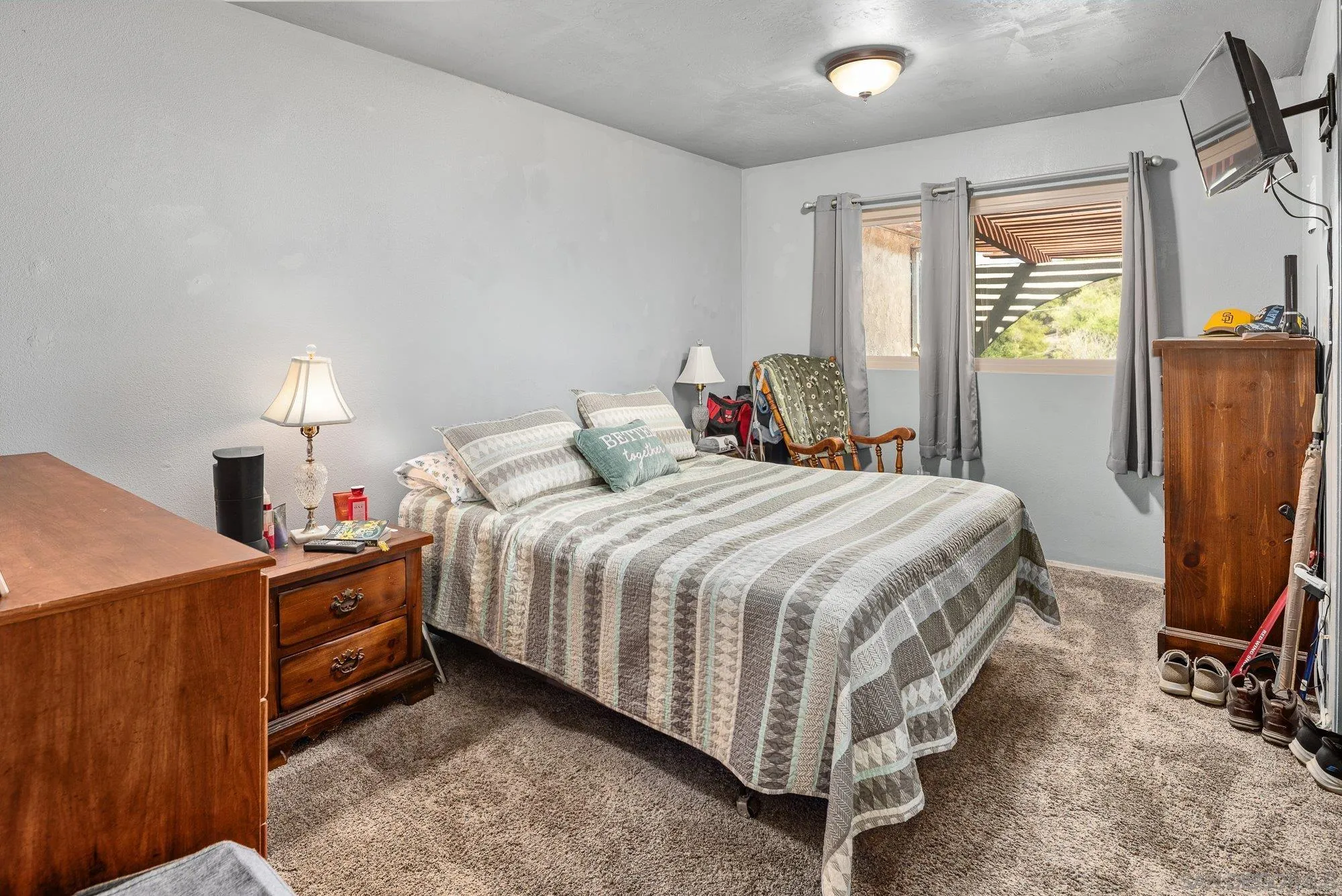 8944 Bower Lane Lakeside, CA 92040 - Photo 20 of 40 a bedroom with a bed and a flat tv screen on the dresser