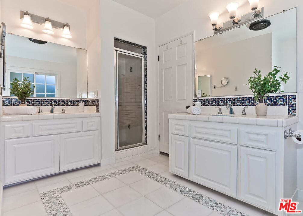 384 North Bonhill Road Los Angeles, CA 90049 - Photo 22 of 32 a bathroom with a sink vanity and a mirror