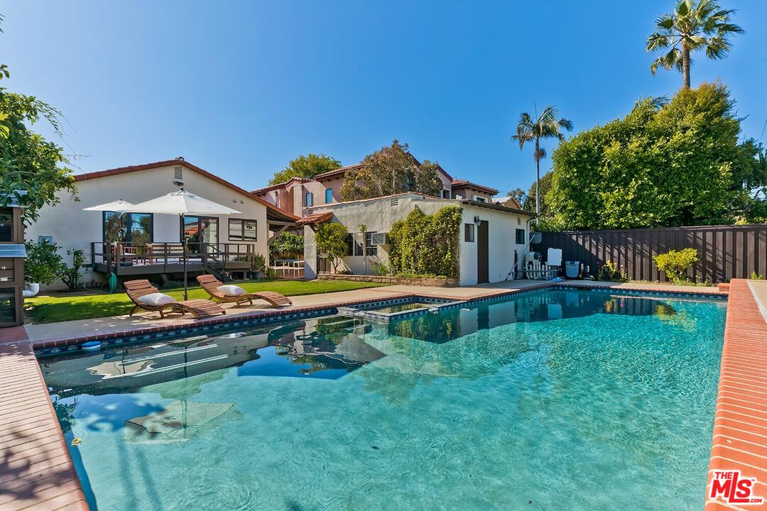 384 North Bonhill Road Los Angeles, CA 90049 - Photo 27 of 32 a view of an house with backyard space and swimming pool