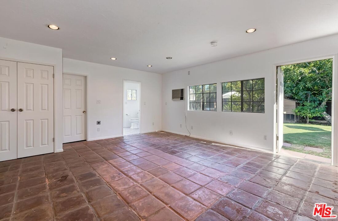 384 North Bonhill Road Los Angeles, CA 90049 - Photo 31 of 32 a view of an empty room with wooden floor and a window