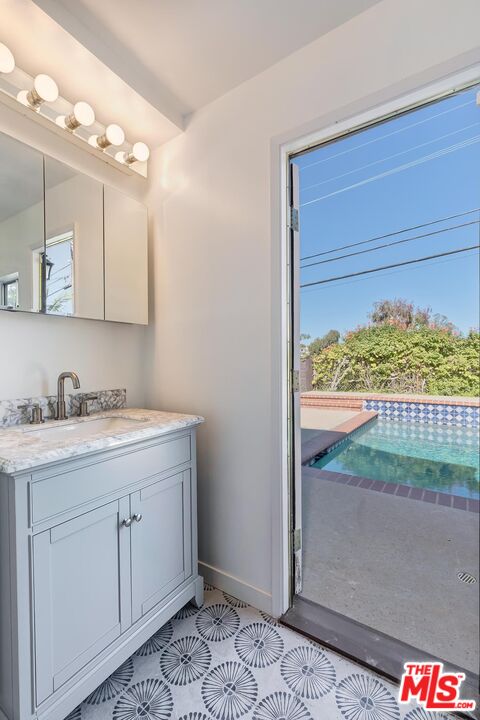 384 North Bonhill Road Los Angeles, CA 90049 - Photo 32 of 32 a bathroom with a sink and a mirror