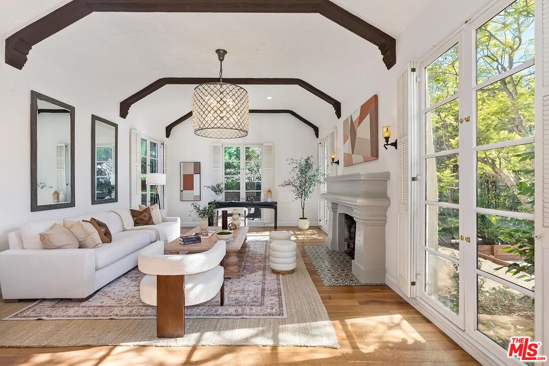 384 North Bonhill Road Los Angeles, CA 90049 - Photo 4 of 32 a living room with fireplace furniture and a large window