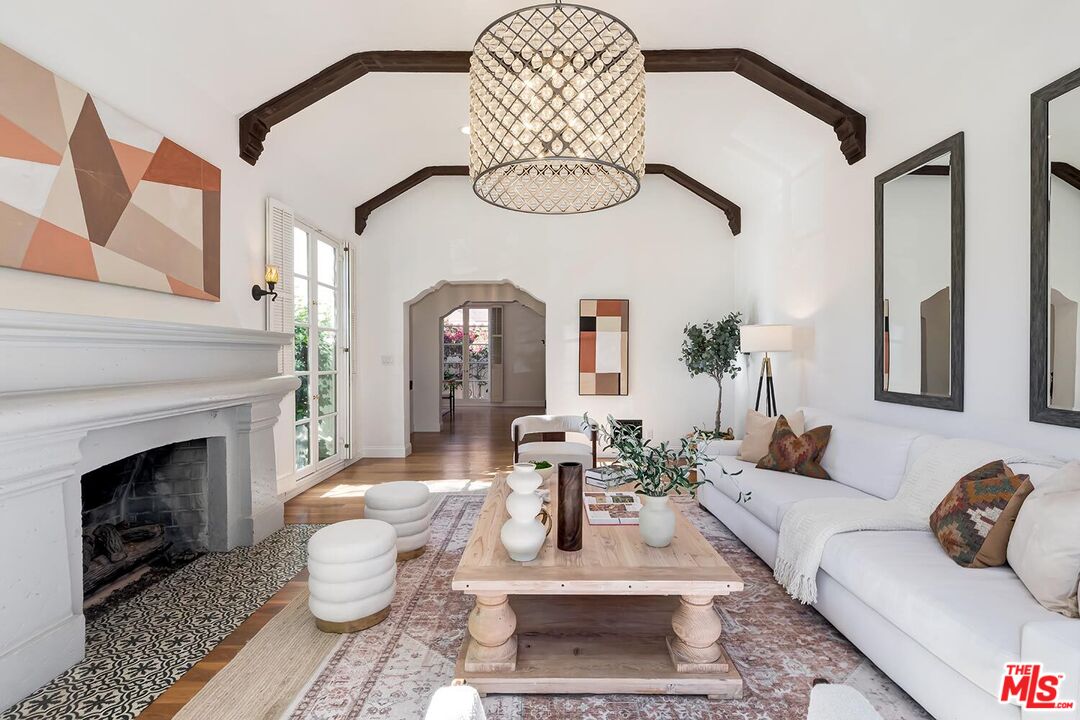 384 North Bonhill Road Los Angeles, CA 90049 - Photo 6 of 32 a living room with furniture a fireplace and a table