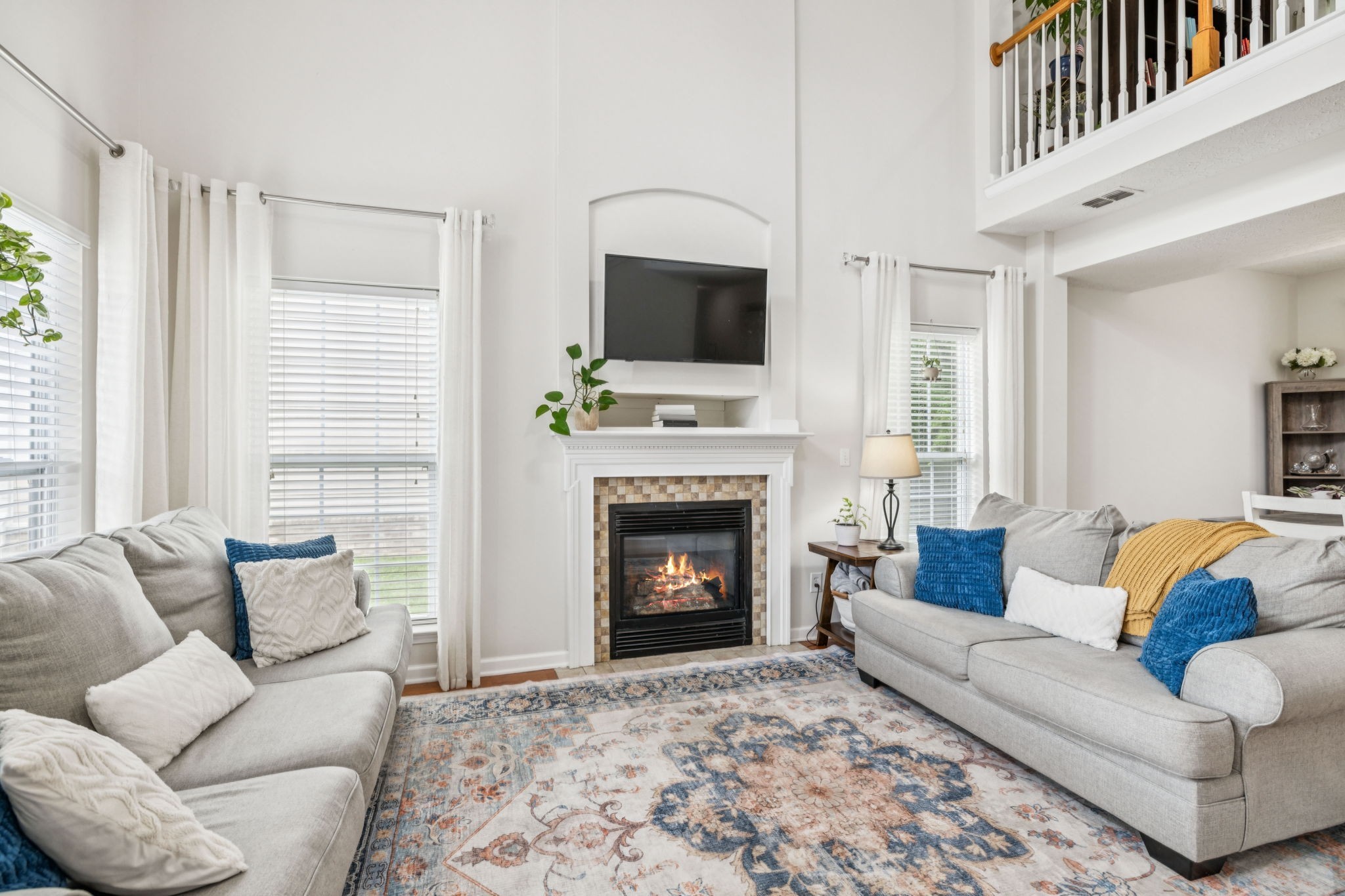 1443 Bern Drive Spring Hill, TN 37174 - Photo 11 of 64 a living room with furniture a flat screen tv and a fireplace