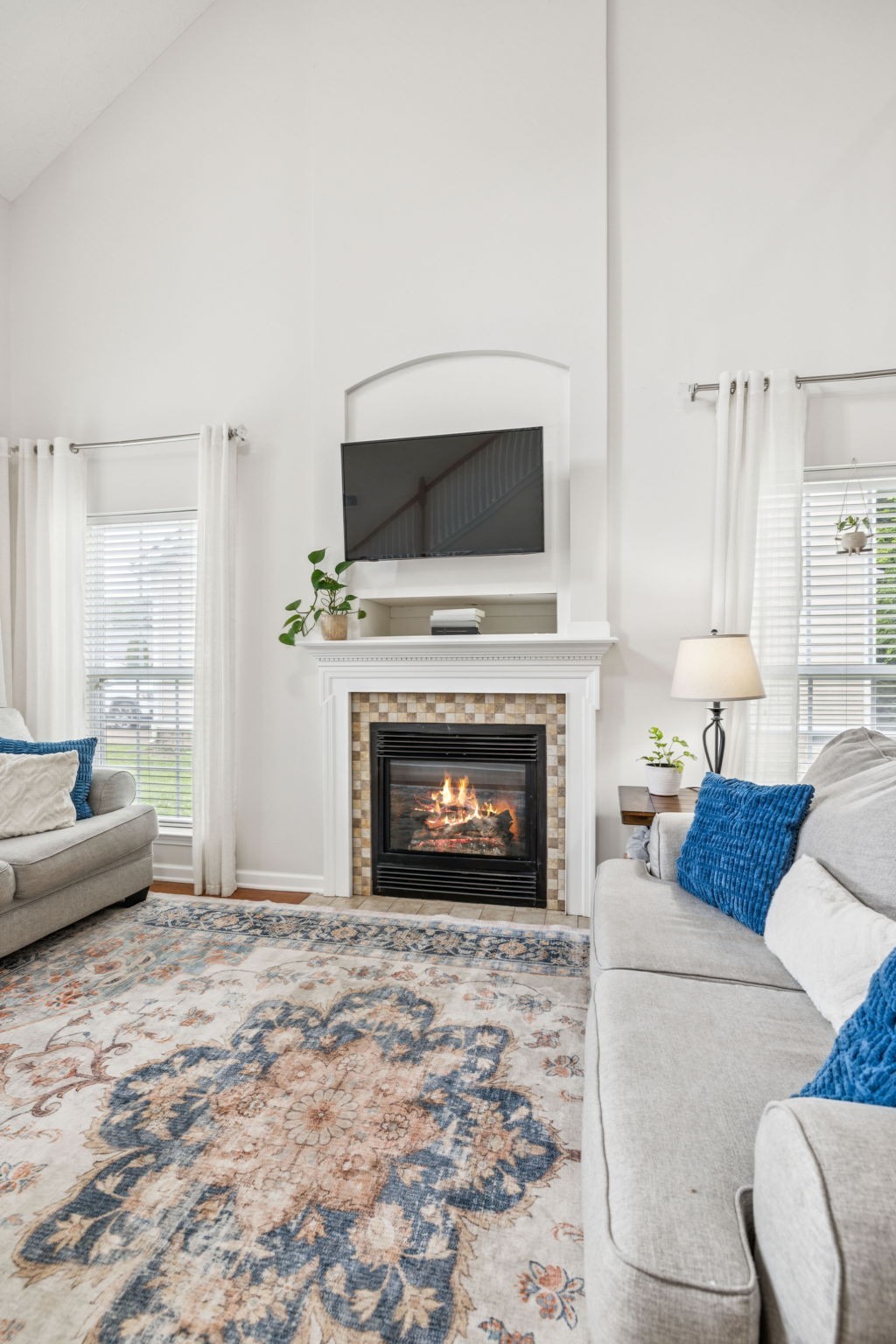 1443 Bern Drive Spring Hill, TN 37174 - Photo 18 of 64 a living room with furniture a flat screen tv and a fireplace