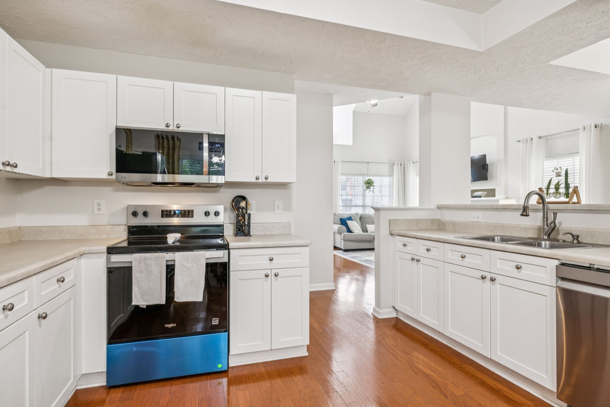 1443 Bern Drive Spring Hill, TN 37174 - Photo 29 of 64 a kitchen with stainless steel appliances granite countertop a stove a sink and white cabinets