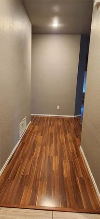 a view of room with wooden floor