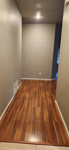 a view of room with wooden floor