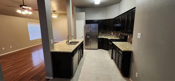 a kitchen with stainless steel appliances granite countertop a sink and a stove