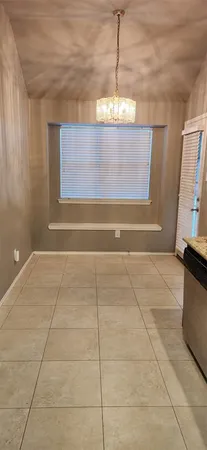 a view of a room with window and chandelier