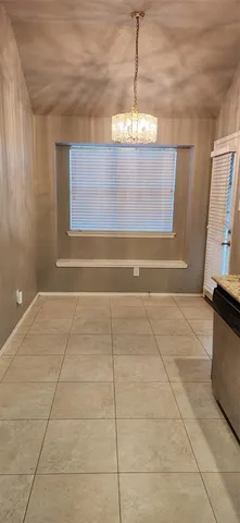 a view of a room with window and chandelier