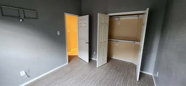 a view of walk in closet with wooden floor