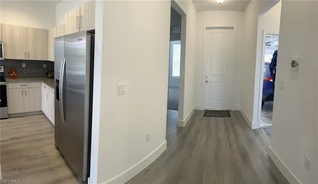 a kitchen with sink and refrigerator