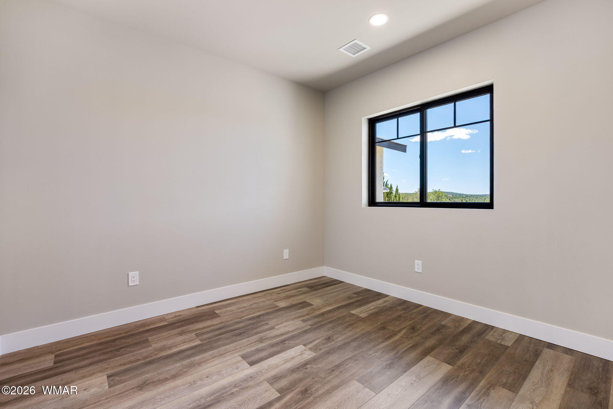 561 South Rock Ridge Drive Show Low, AZ 85901 - Photo 14 of 28 a view of an empty room with wooden floor and a window