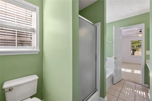 a bathroom with a toilet and a shower